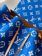 Louis Vuitton blue monogram bag with tan shoulder straps and hanging leather loops