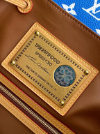 Louis Vuitton bag gold-tone nameplate on brown leather interior, stitched trim detail