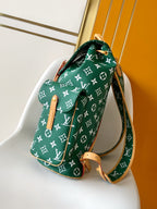 Louis Vuitton green monogram handbag with crossbody strap and tan leather trim