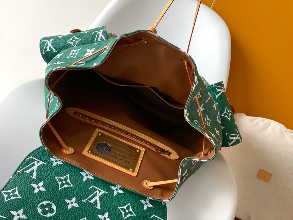 Louis Vuitton green monogram bag open to brown interior with inner pocket