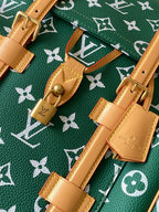 Louis Vuitton green monogram bag with tan straps, buckles, and gold hardware