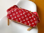 Louis Vuitton red monogram mini bag with tan leather strap and top handle.
