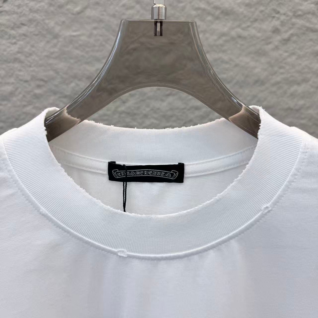 White T-shirt neckline close-up with black brand tag at inner collar