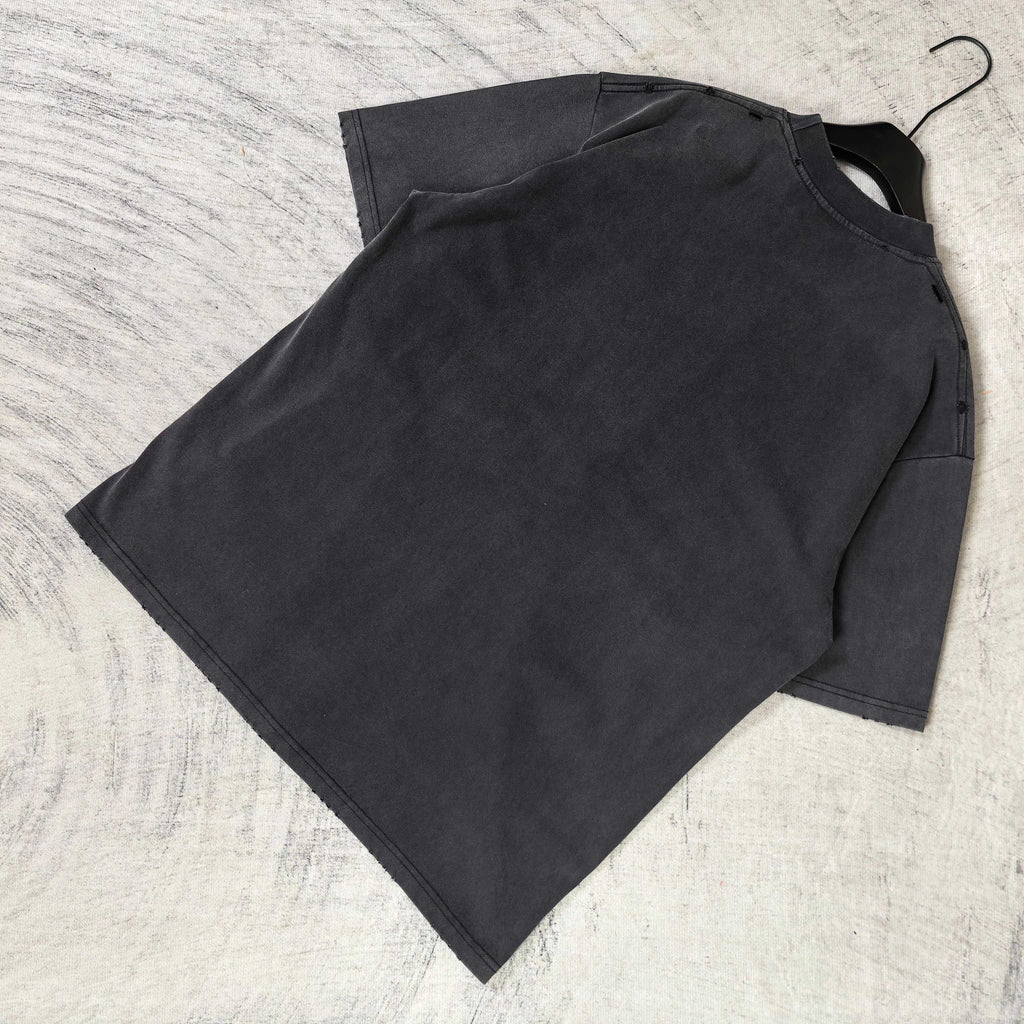 Black graphic T-shirt laid flat, plain back with short sleeves