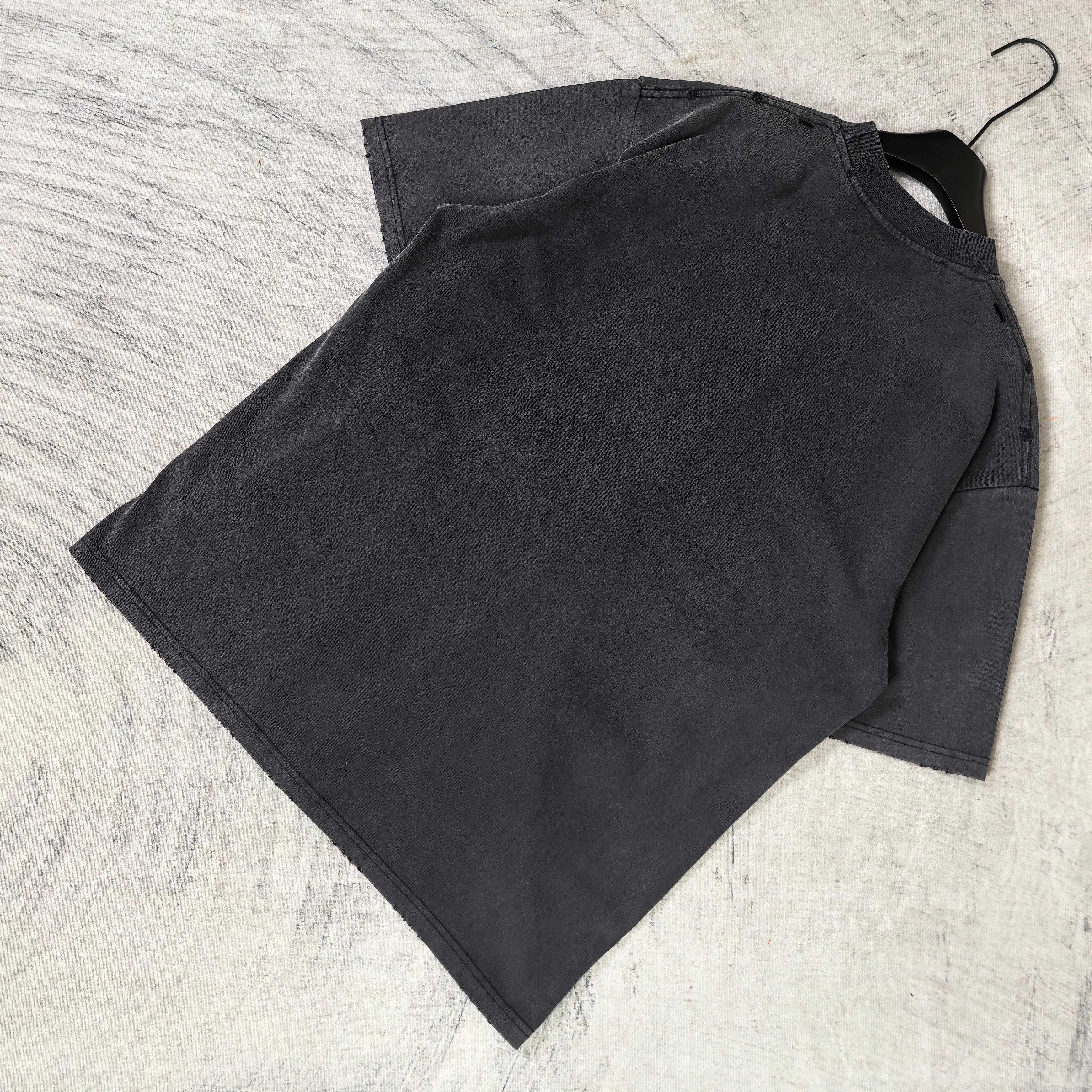 Black graphic T-shirt laid flat, plain back with short sleeves