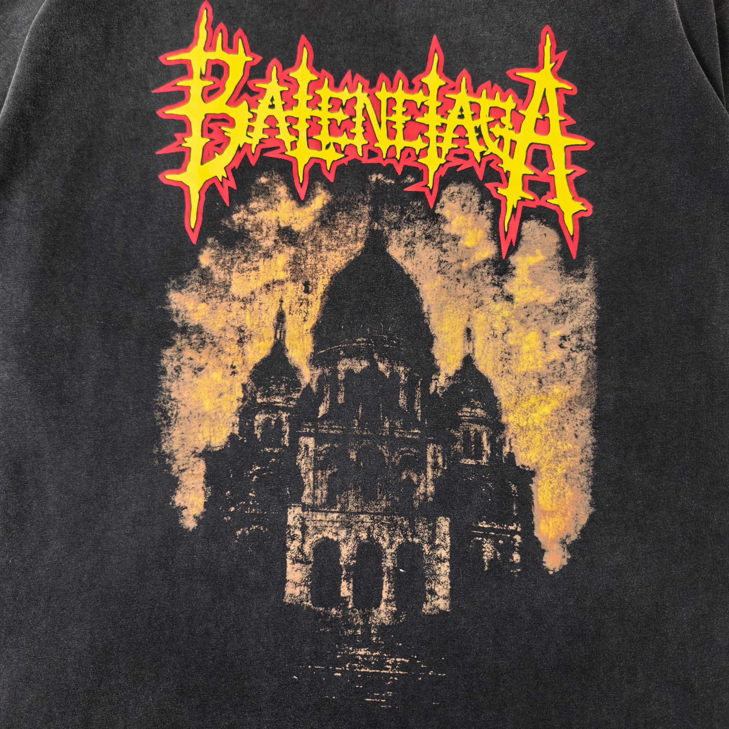 Black T-shirt close-up of red/yellow cathedral graphic print