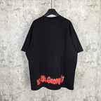 Black graphic T-shirt, back view with red and blue lettering near lower hem