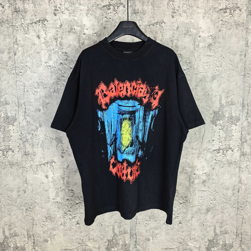 Black graphic T-shirt with multicolor face print on front, short sleeves, crew neck