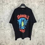 Black graphic T-shirt with multicolor face print on front, short sleeves, crew neck