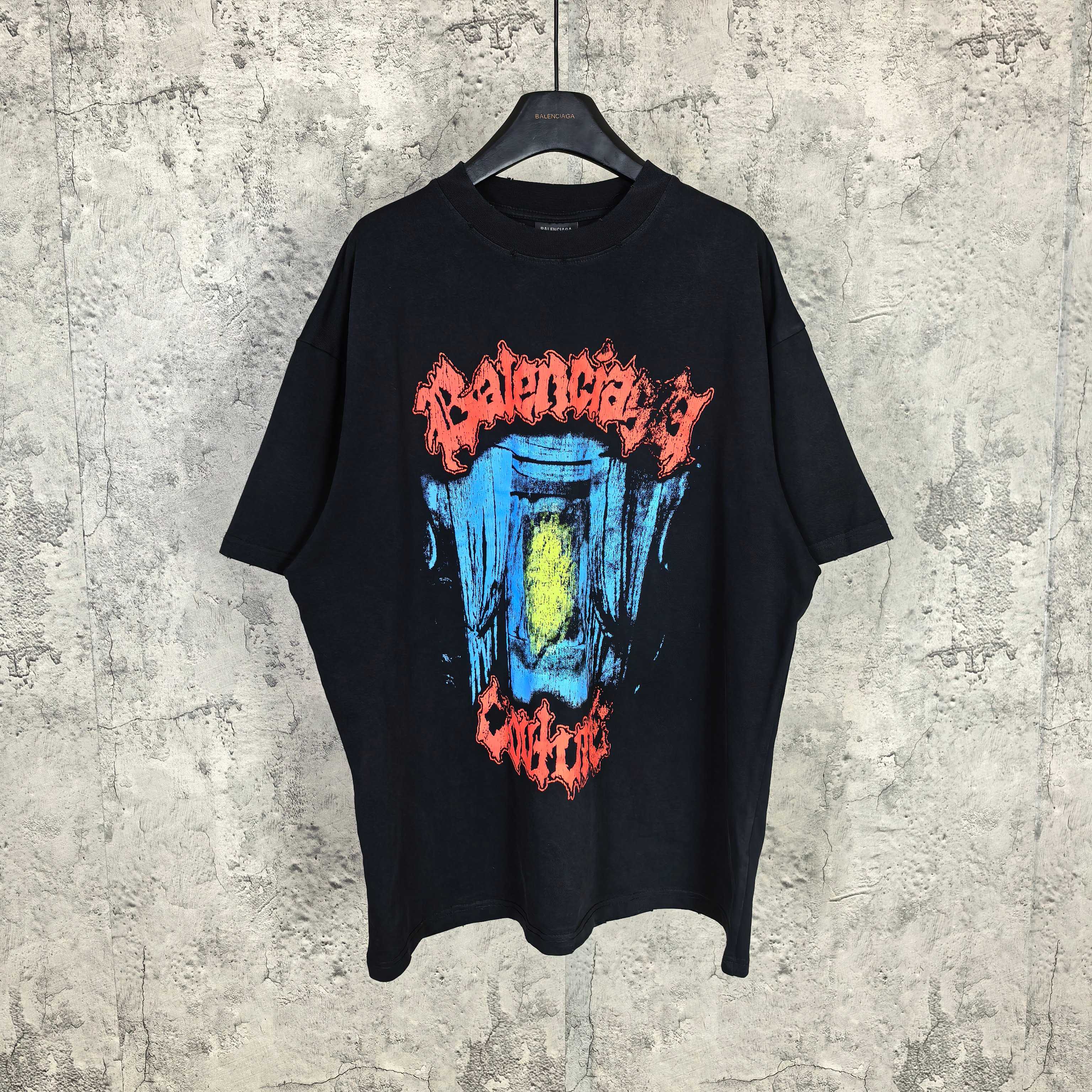 Black graphic T-shirt with multicolor face print on front, short sleeves, crew neck