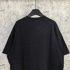 Black T-shirt back view with plain fabric and short sleeves, crew neckline