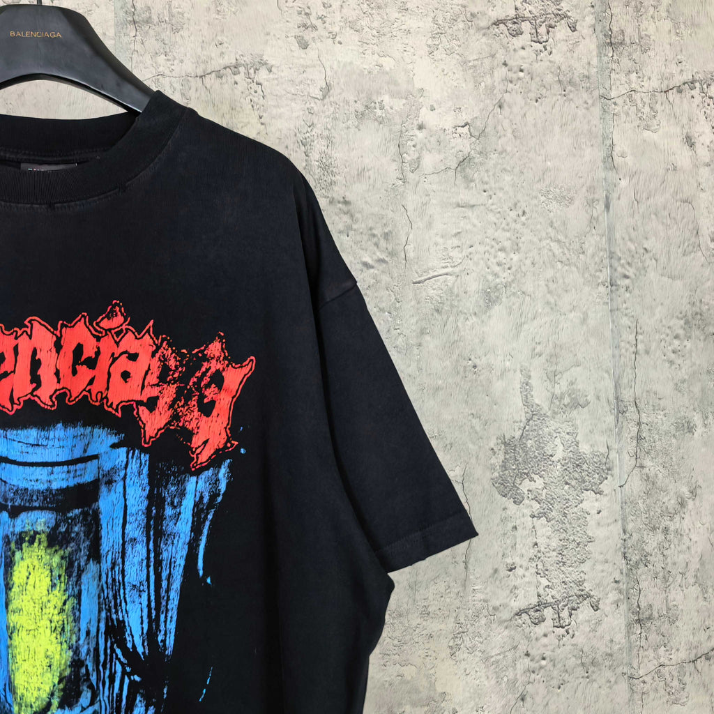Black T-shirt side crop with partial multicolor face print in blue, yellow, red