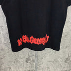 Black graphic T-shirt with red stylized lettering across the hem