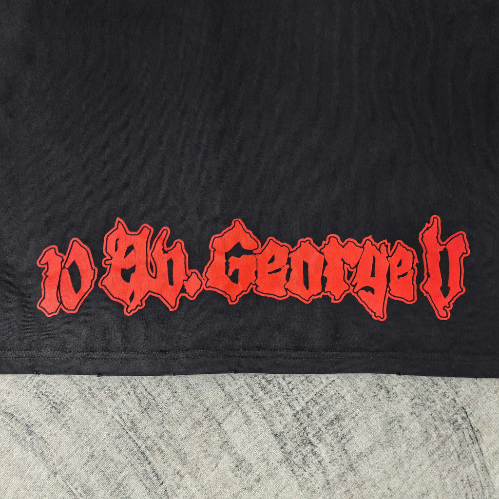 Black graphic T-shirt close-up of red stylized lettering