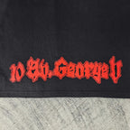 Black graphic T-shirt close-up of red stylized lettering