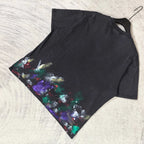 Balenciaga short-sleeve T-shirt laid flat, black with colorful paint print on left side