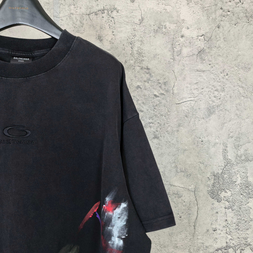 Balenciaga short-sleeve T-shirt close-up, black with chest logo and paint print on sleeve