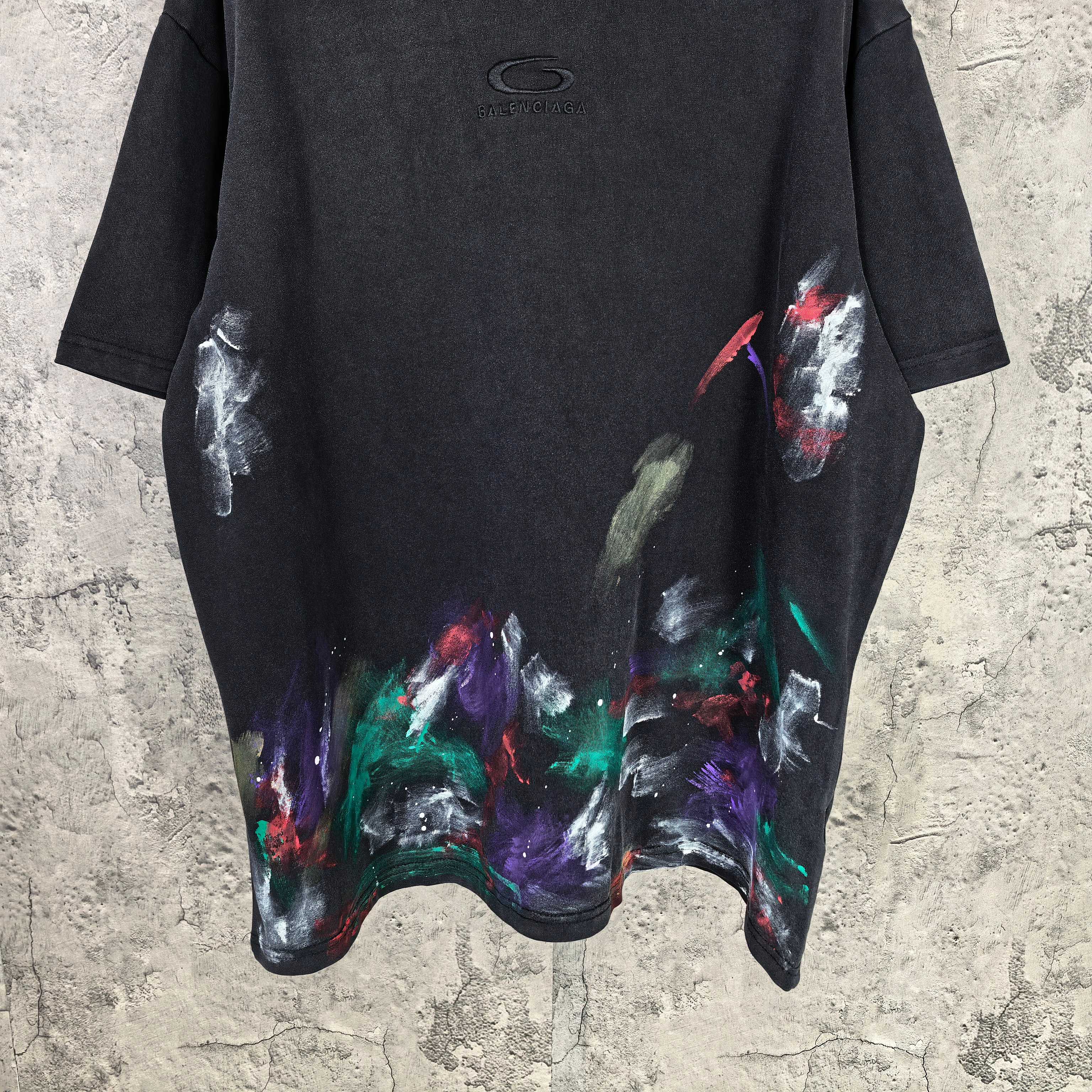 Balenciaga short-sleeve T-shirt front, black with large colorful abstract paint print on hem