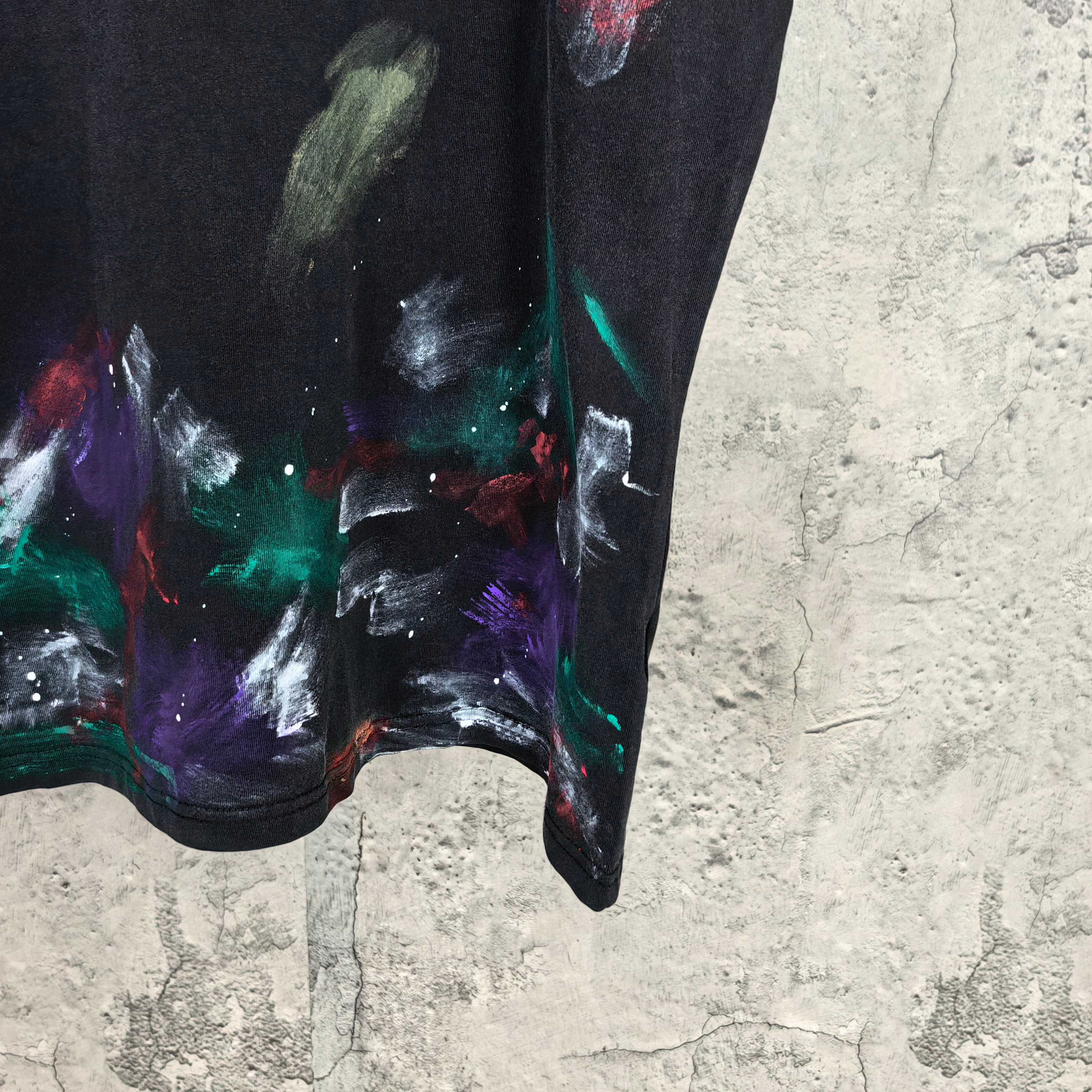 Dark graphic shorts with multicolor splash print and curved hem