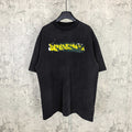 Black short-sleeve T-shirt with Balenciaga logo graphic in yellow, green, and white.