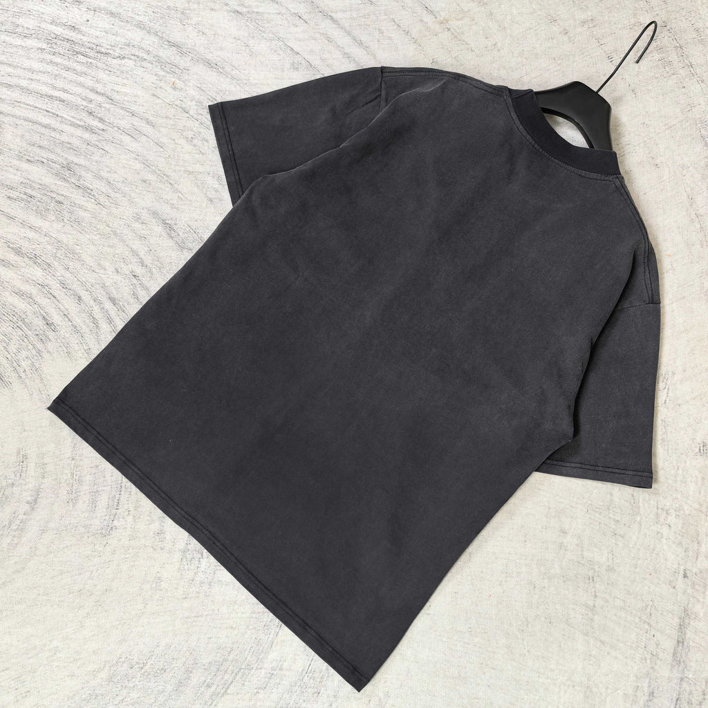 Black short-sleeve T-shirt laid flat, crew neck and short sleeves.