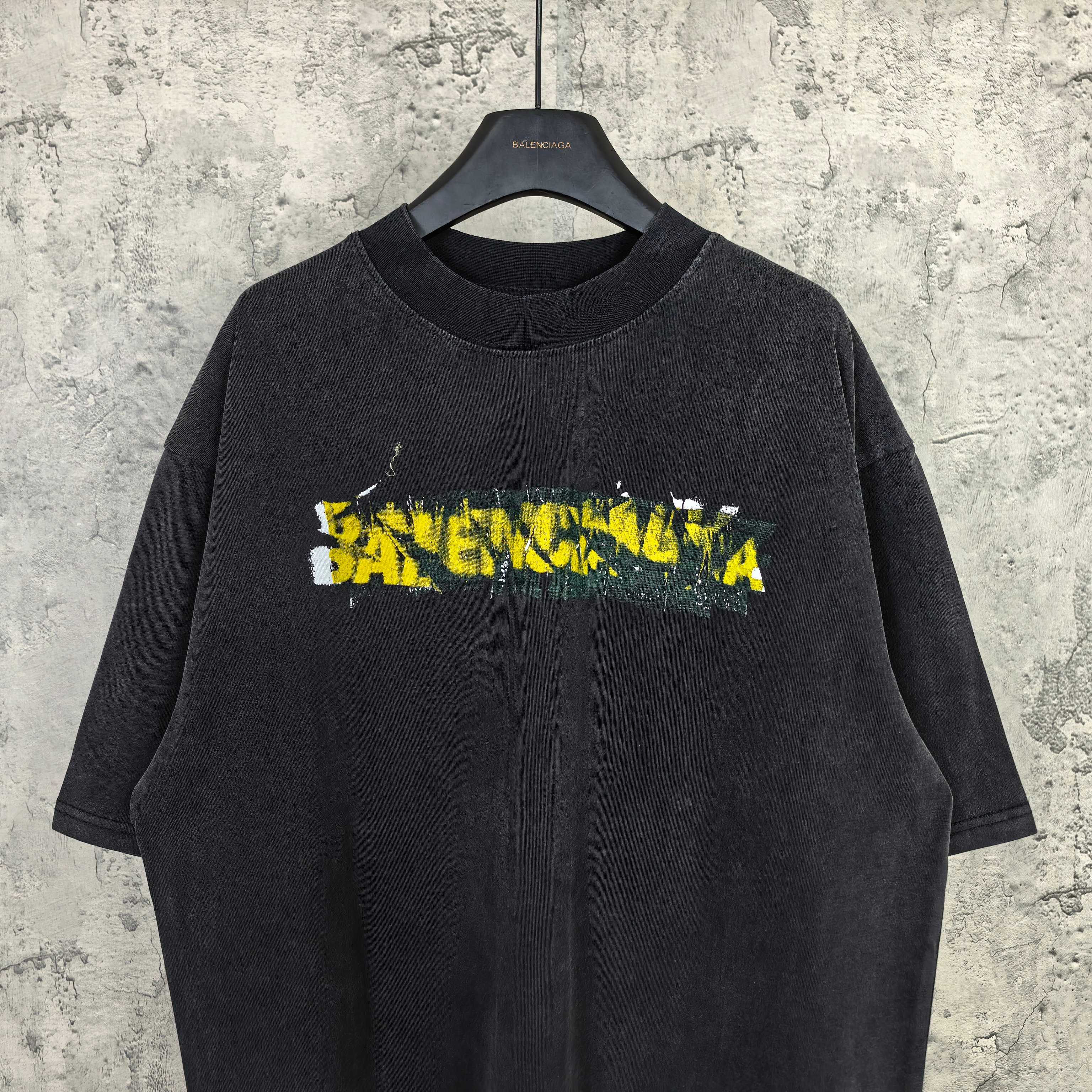 Black short-sleeve T-shirt with Balenciaga logo graphic, crew neck.