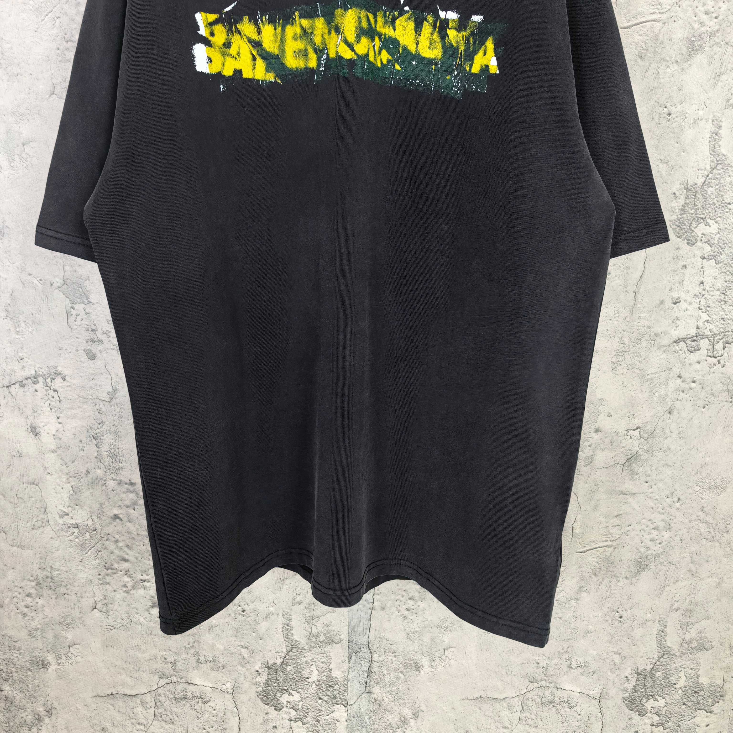 Black short-sleeve T-shirt with Balenciaga logo print near the chest.