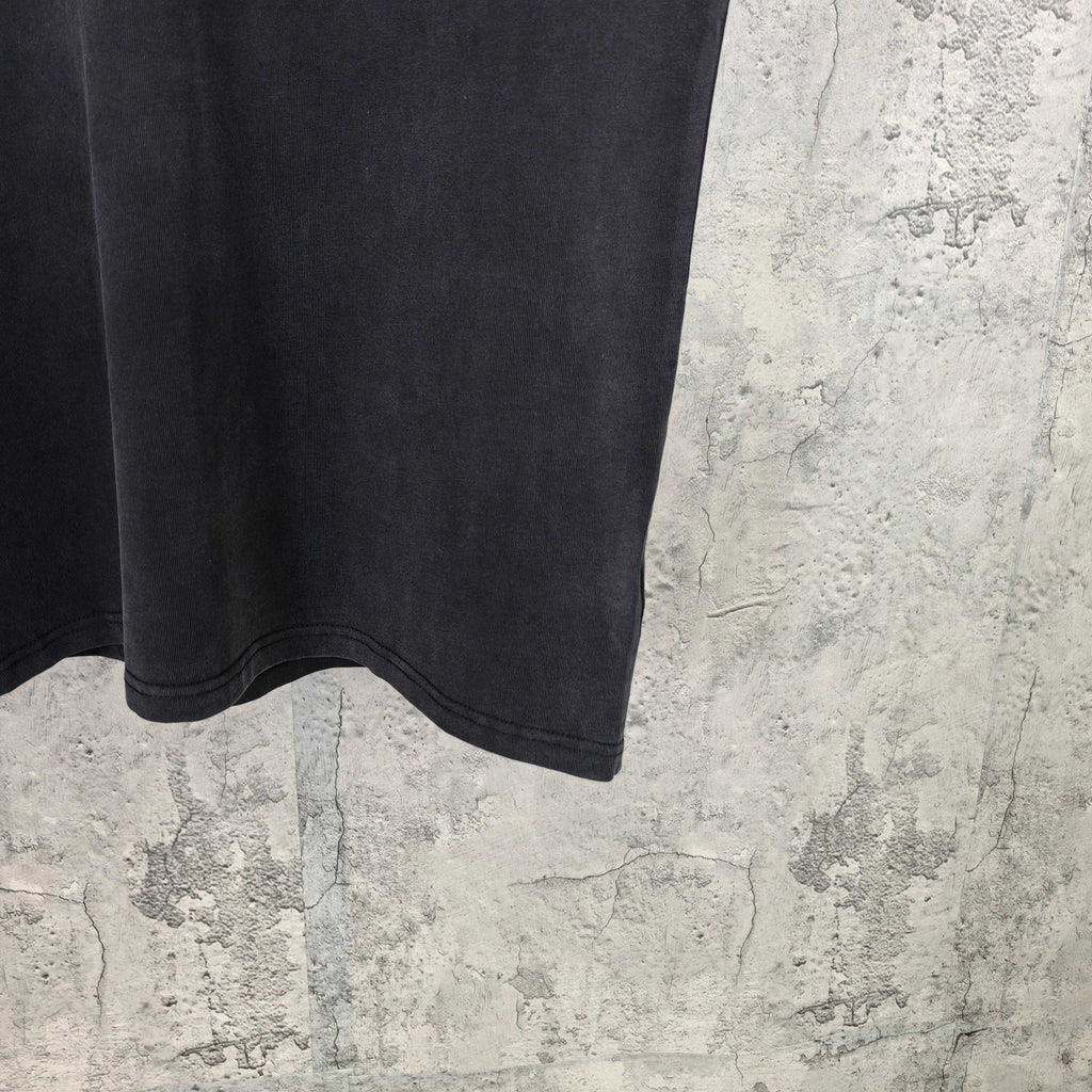 Black short-sleeve T-shirt hem and sleeve cuff detail, no visible logo.