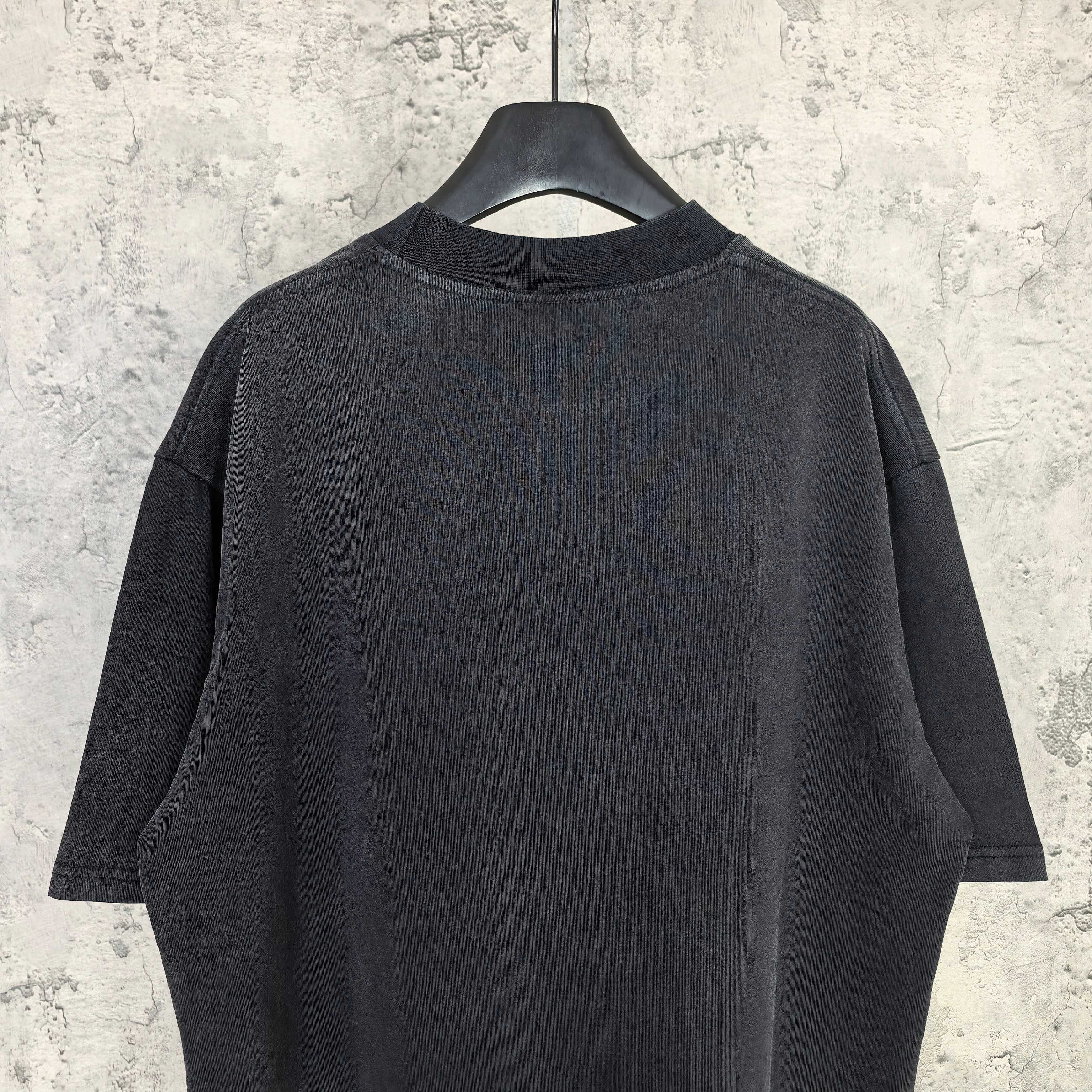 Black short-sleeve T-shirt, back view with crew neck and loose shoulders.