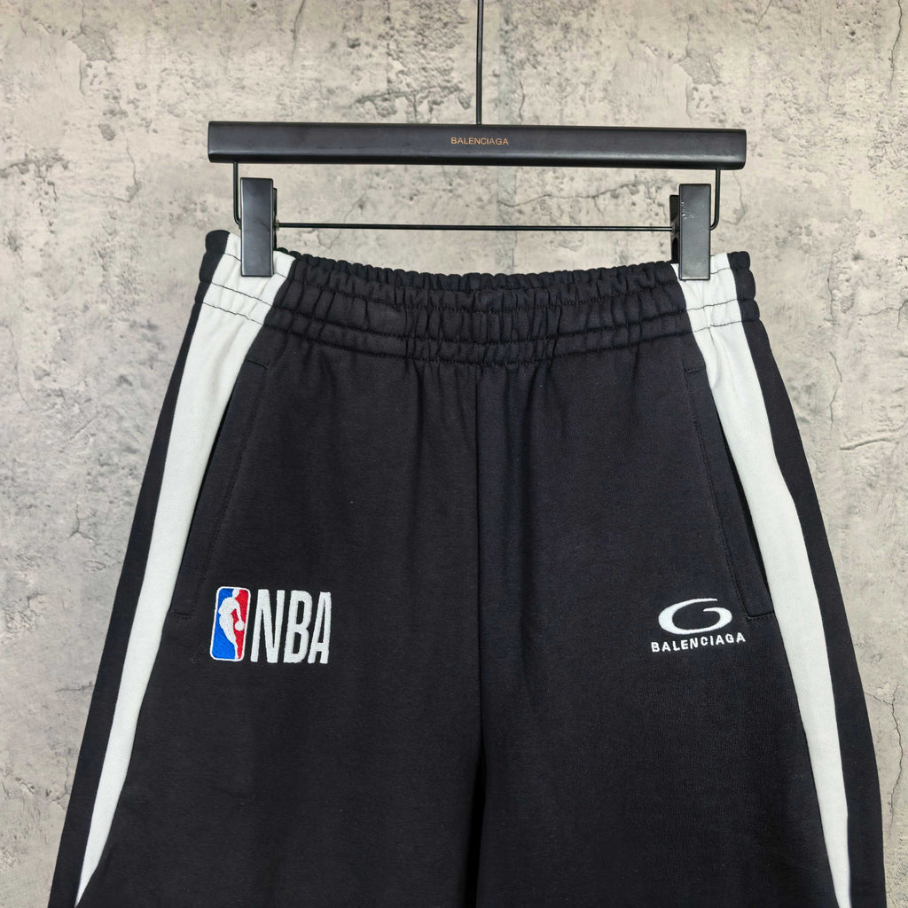 Black shorts with elastic waistband, white side stripes, NBA and Balenciaga emblems