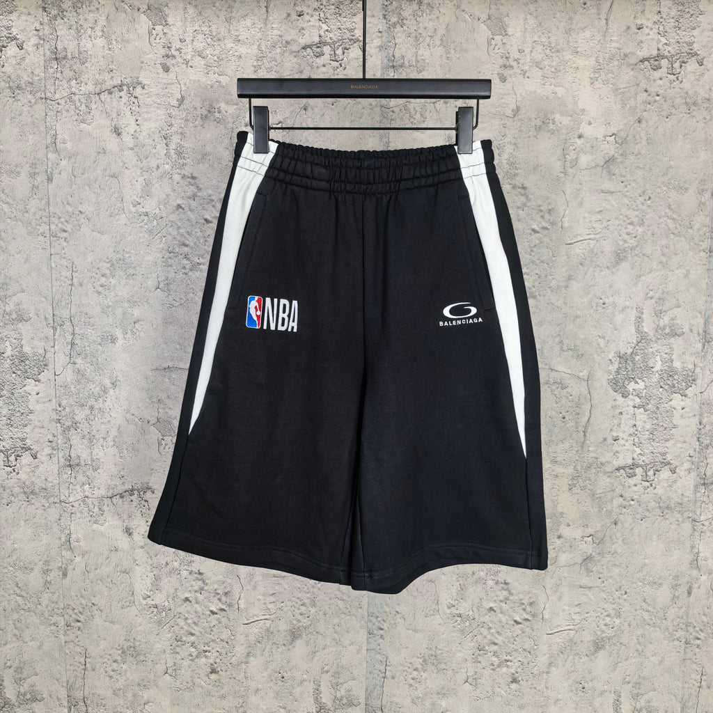 Black shorts with elastic waistband, white side stripes, NBA and Balenciaga logos