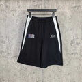 Black shorts with elastic waistband, white side stripes, NBA and Balenciaga logos