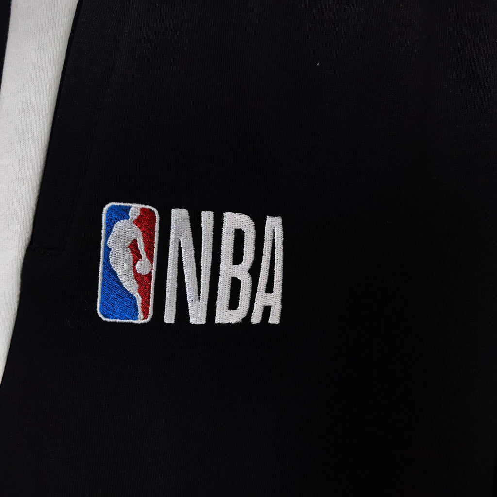 NBA logo patch on black shorts with white side stripe