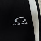 Balenciaga oval logo and text on black shorts, with white side stripe