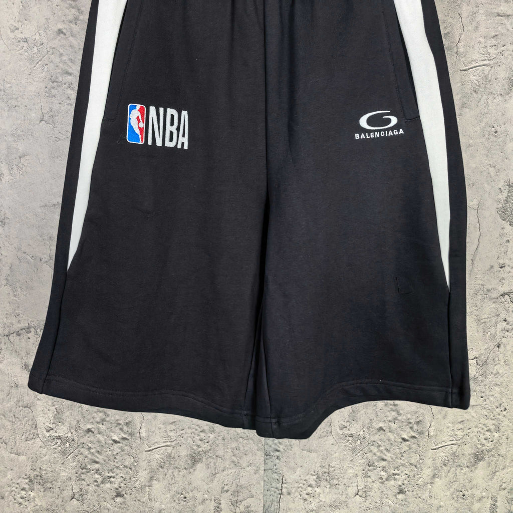 Black Balenciaga shorts with white side stripes, NBA and Balenciaga logos