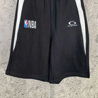 Black Balenciaga shorts with white side stripes, NBA and Balenciaga logos
