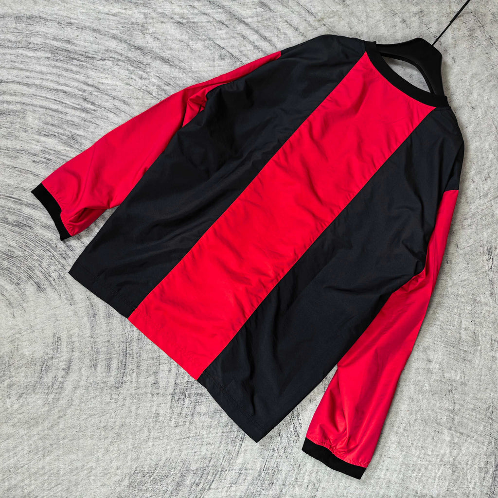 Long-sleeve Balenciaga jersey laid flat, black sleeves with bold red center stripe.