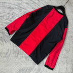 Long-sleeve Balenciaga jersey laid flat, black sleeves with bold red center stripe.