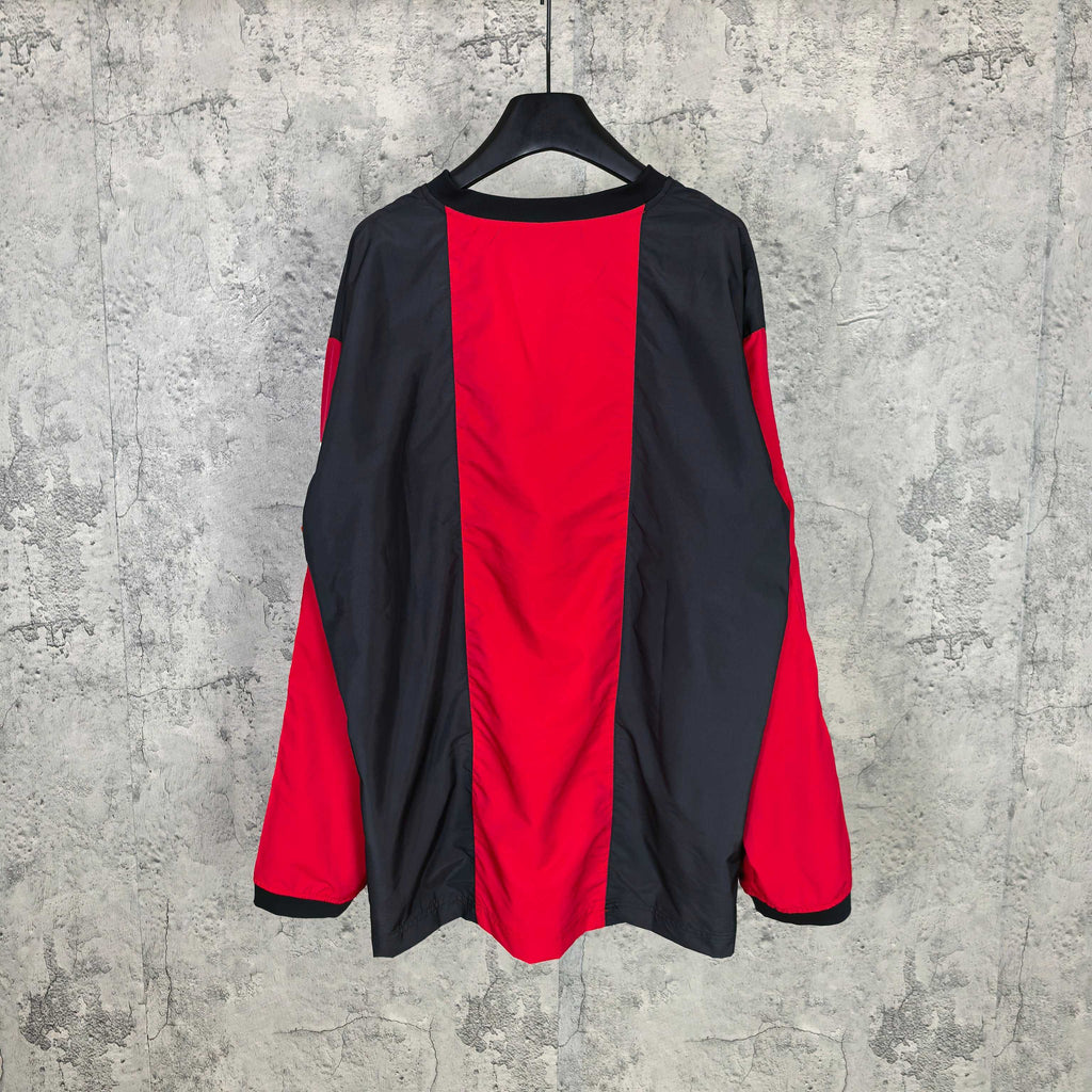 Long-sleeve Balenciaga jersey with black back and red side panels, relaxed drape.
