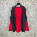 Long-sleeve Balenciaga jersey with black back and red side panels, relaxed drape.