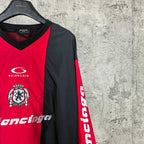 Balenciaga jersey side close-up with black sleeve, red panel, and vertical sleeve lettering.