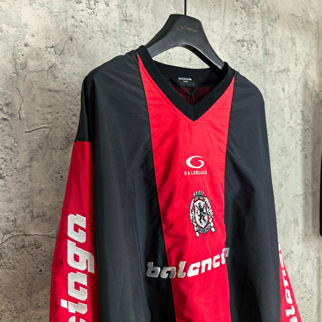 Long-sleeve Balenciaga jersey front with red center, black sleeves, crest and logo details.