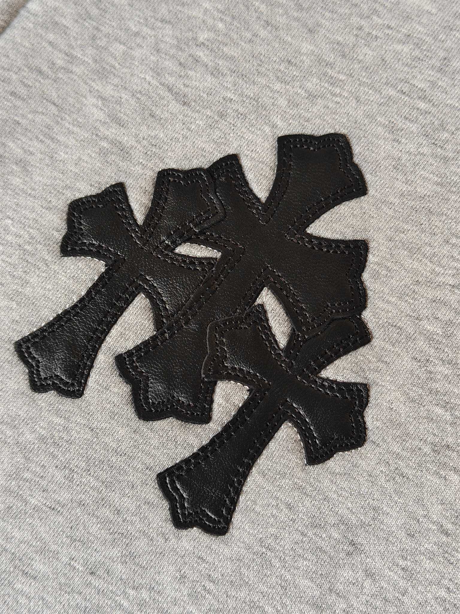 Light gray hoodie fabric with black embroidered cross emblem