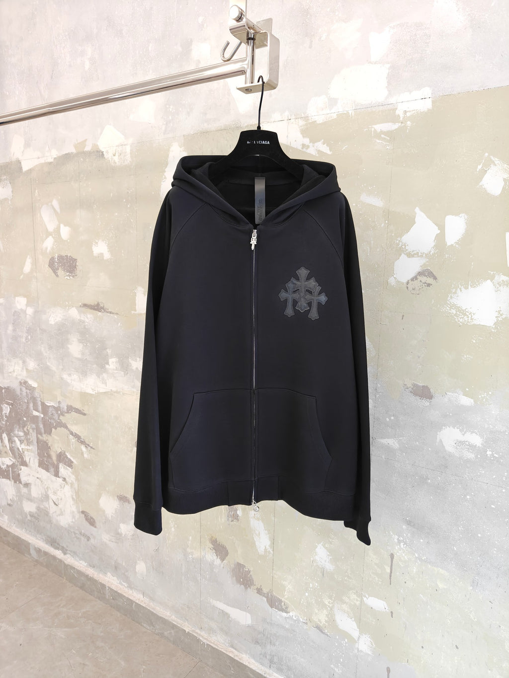 Dark zip-up hoodie with attached hood and front full-length zipper