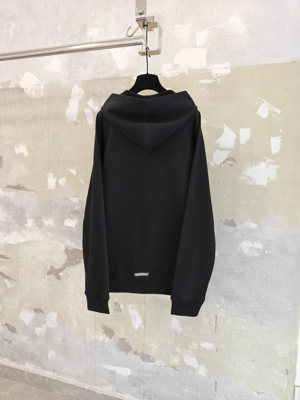 Dark zip-up hoodie back view with hood and full-length zipper