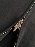 Gold-tone zipper with double sliders on dark hoodie