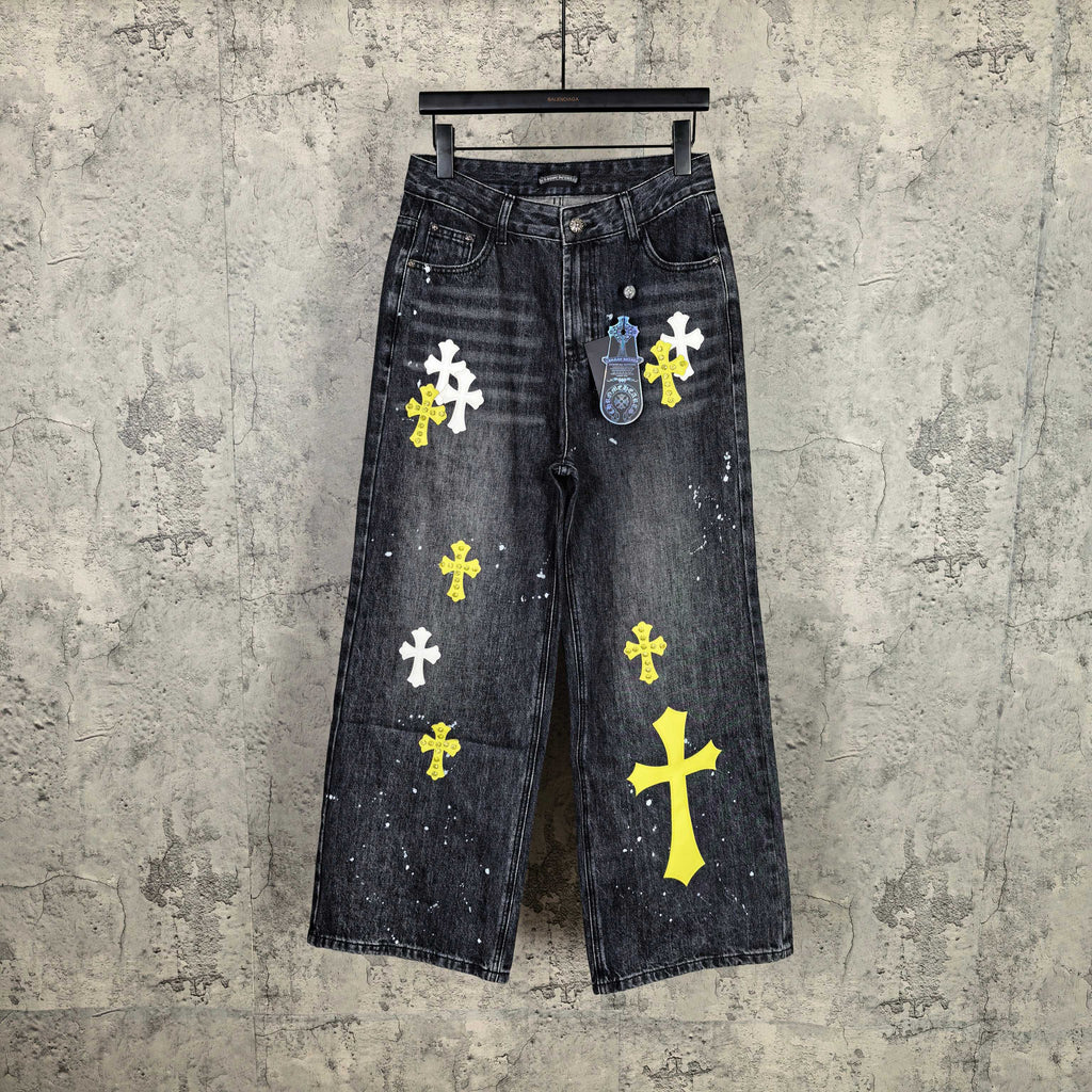 Dark denim pants with yellow and white cross graphics and speckled details