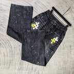 Dark denim pants folded with pockets and cross graphics in yellow and white