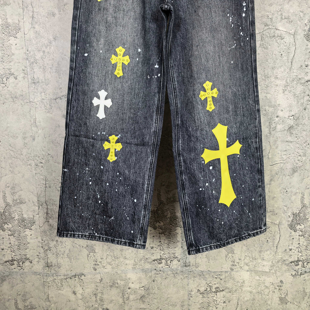 Dark denim pants front view with yellow and white cross prints on both legs