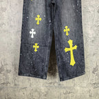 Dark denim pants front view with yellow and white cross prints on both legs